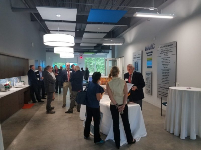 Guests gather around the small business exhibitors at the Industry Showcase.